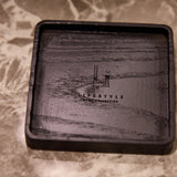 Black rectangular tray with engraved design on a marble surface